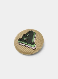 A embroidered badge pin