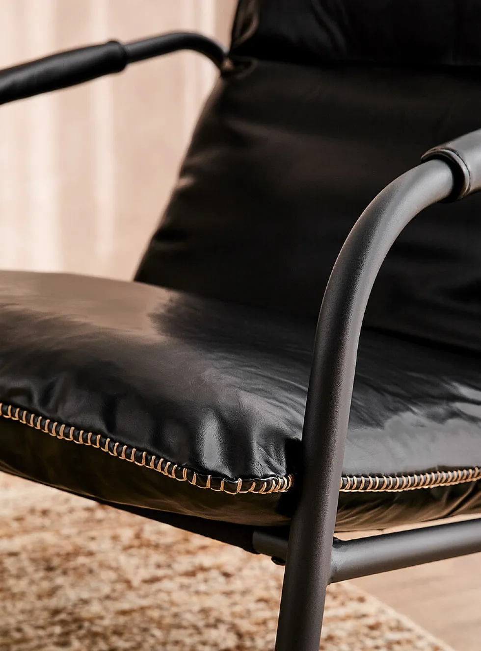 Accent stitching faux-leather lounge chair