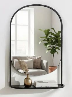 Black metal arched mirror with shelf