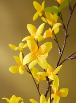 Bright yellow artificial forsythia branch