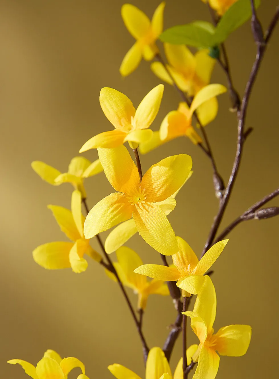 Bright yellow artificial forsythia branch