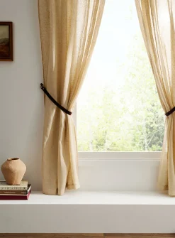 Brown leather curtain holders