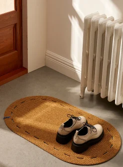Dotted cutouts oval doormat