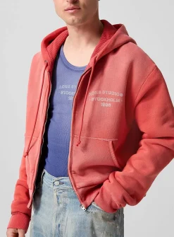 Faded red zip-up hooded sweatshirt
