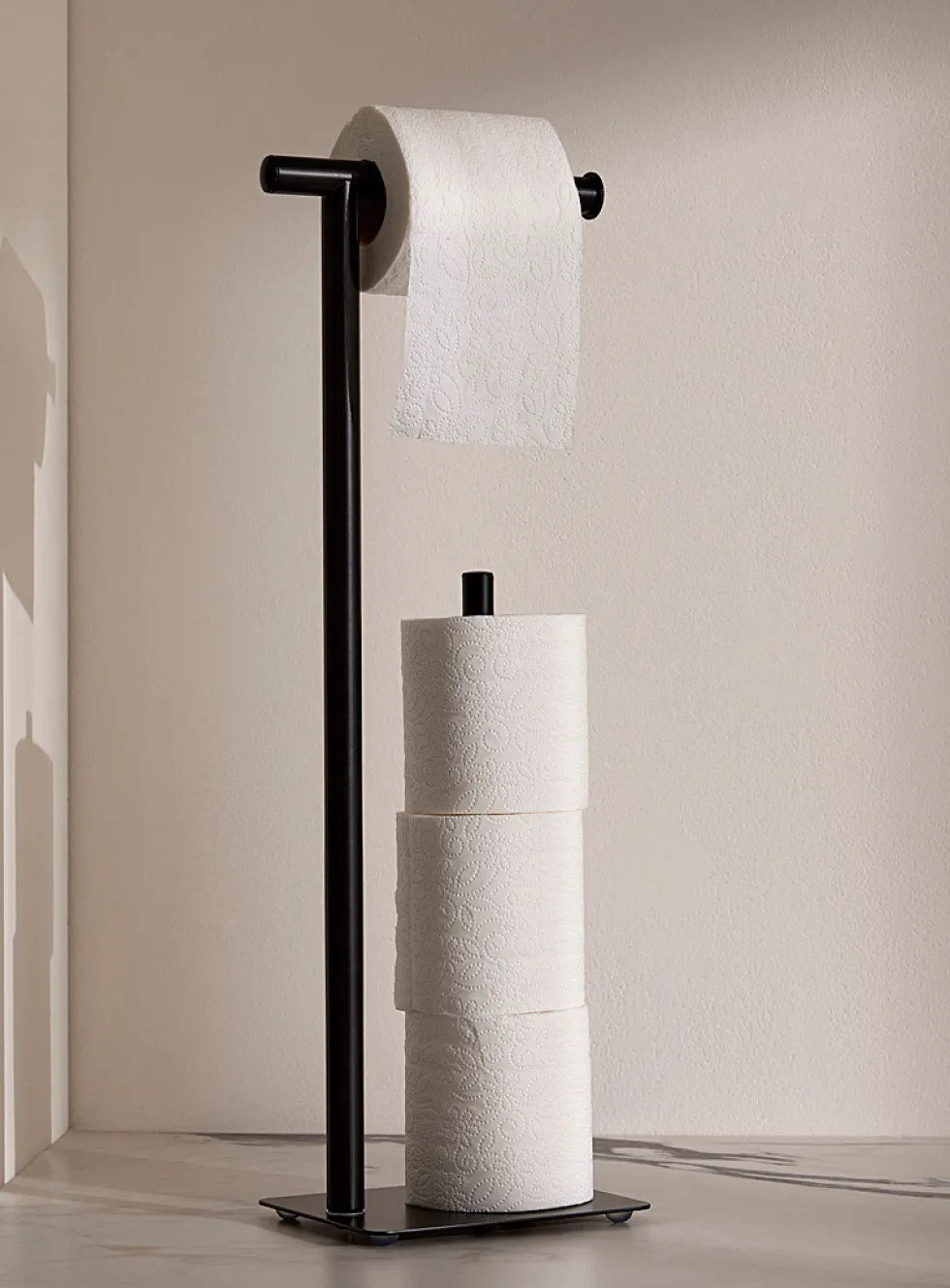 Minimalist toilet paper holder with reserve