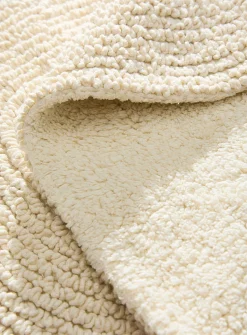 Oval reversible bath mat
