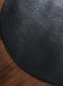 Round faux-leather placemat