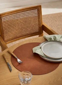 Round faux-leather placemat