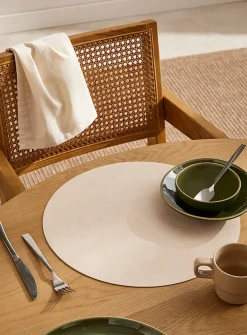 Round faux-leather placemat