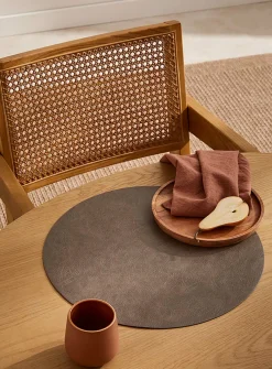Round faux-leather placemat