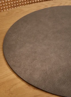 Round faux-leather placemat