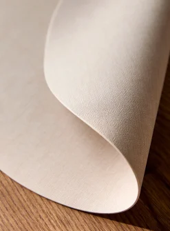 Round heathered faux-leather placemat