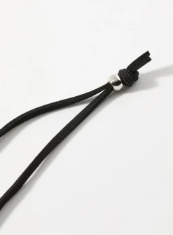Sinuous hammered medallion cord necklace