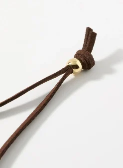 Sinuous hammered medallion cord necklace