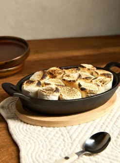 Small cast iron oval skillet with bamboo tray