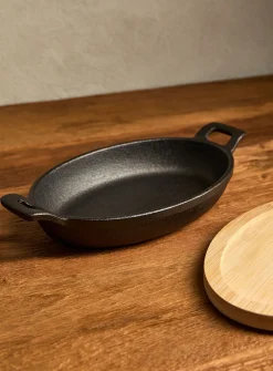 Small cast iron oval skillet with bamboo tray