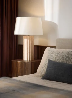Table lamp with fluted travertine base