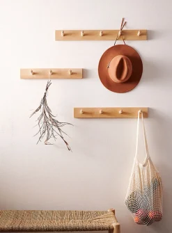Wall-mounted dowel coat rack