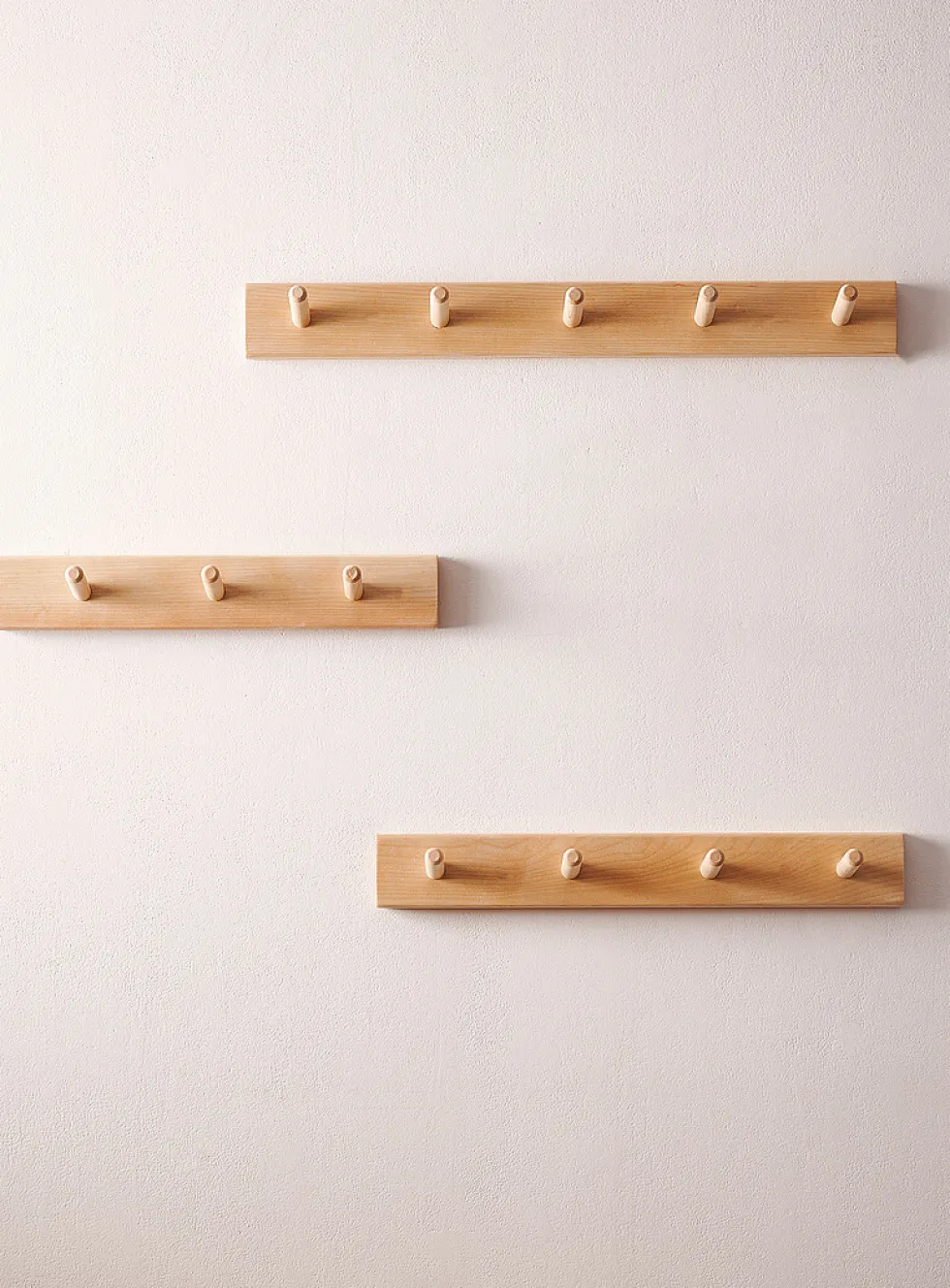 Wall-mounted dowel coat rack