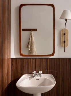 Walnut finish subtly rounded mirror