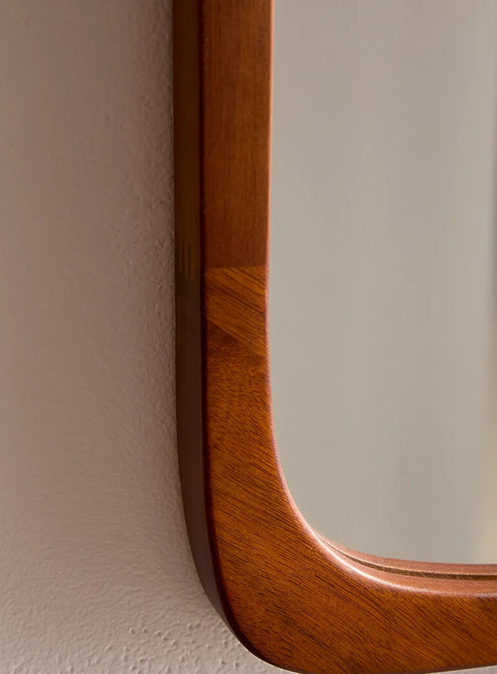 Walnut finish subtly rounded mirror