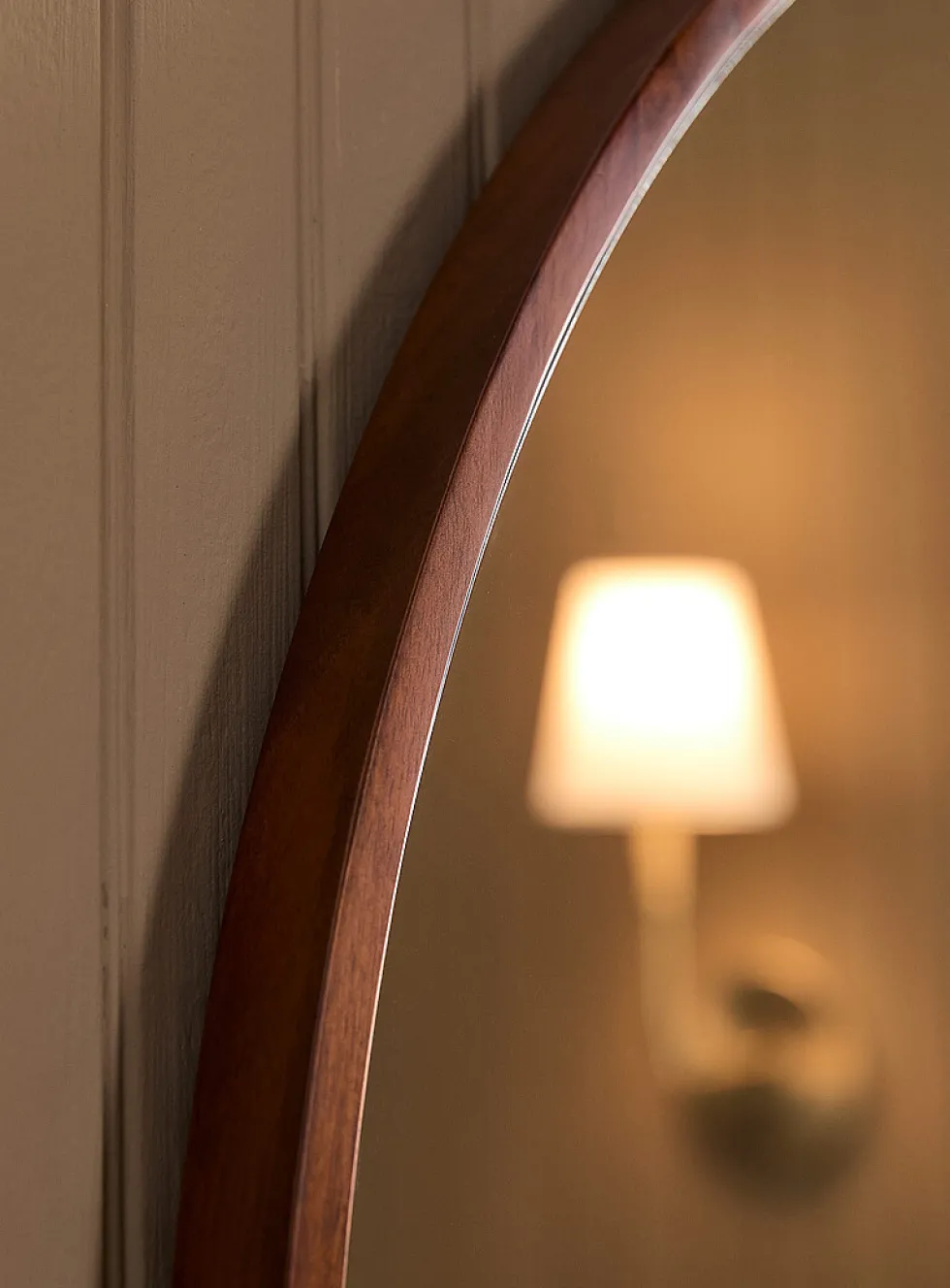 Walnut-finished round frame mirror