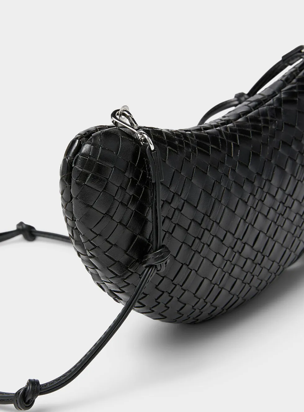 Woven leather crescent clutch
