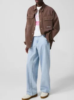Light blue wide-leg jeans with curved logo