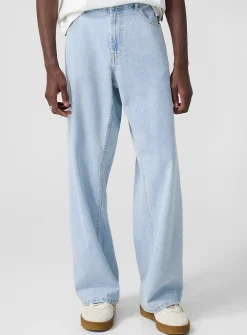 Light blue wide-leg jeans with curved logo
