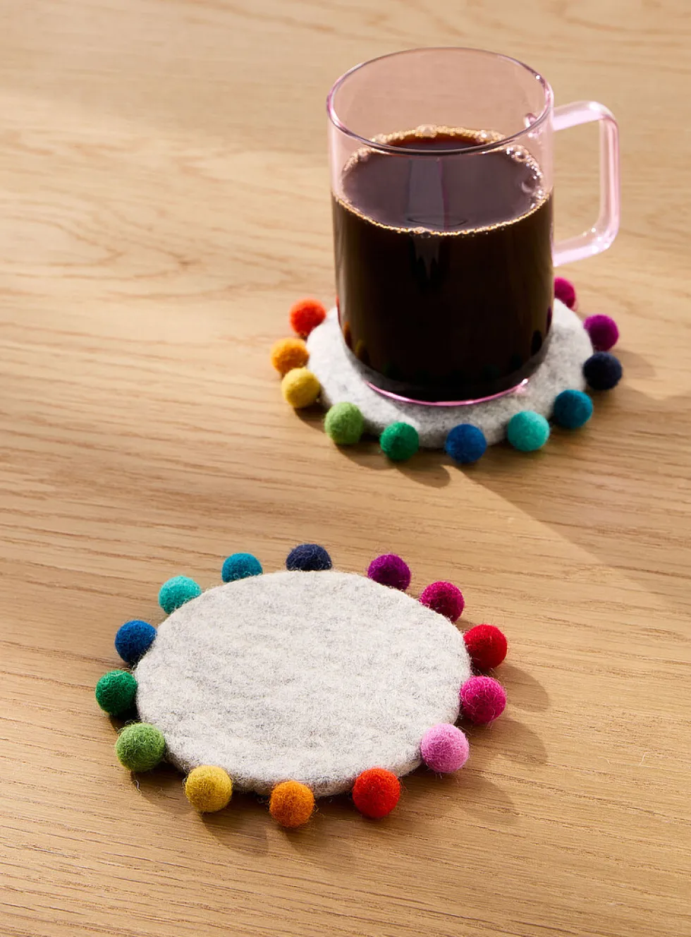 Multicoloured balls border wool coasters