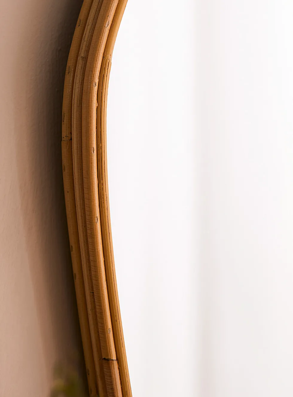 Rattan trim asymmetrical mirror