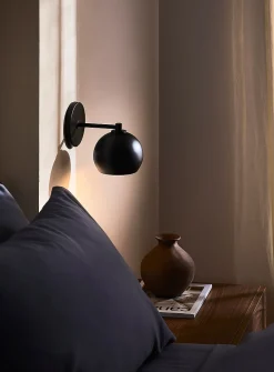 Sleek spehrical shade wall sconce