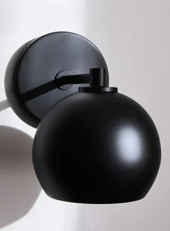 Sleek spehrical shade wall sconce