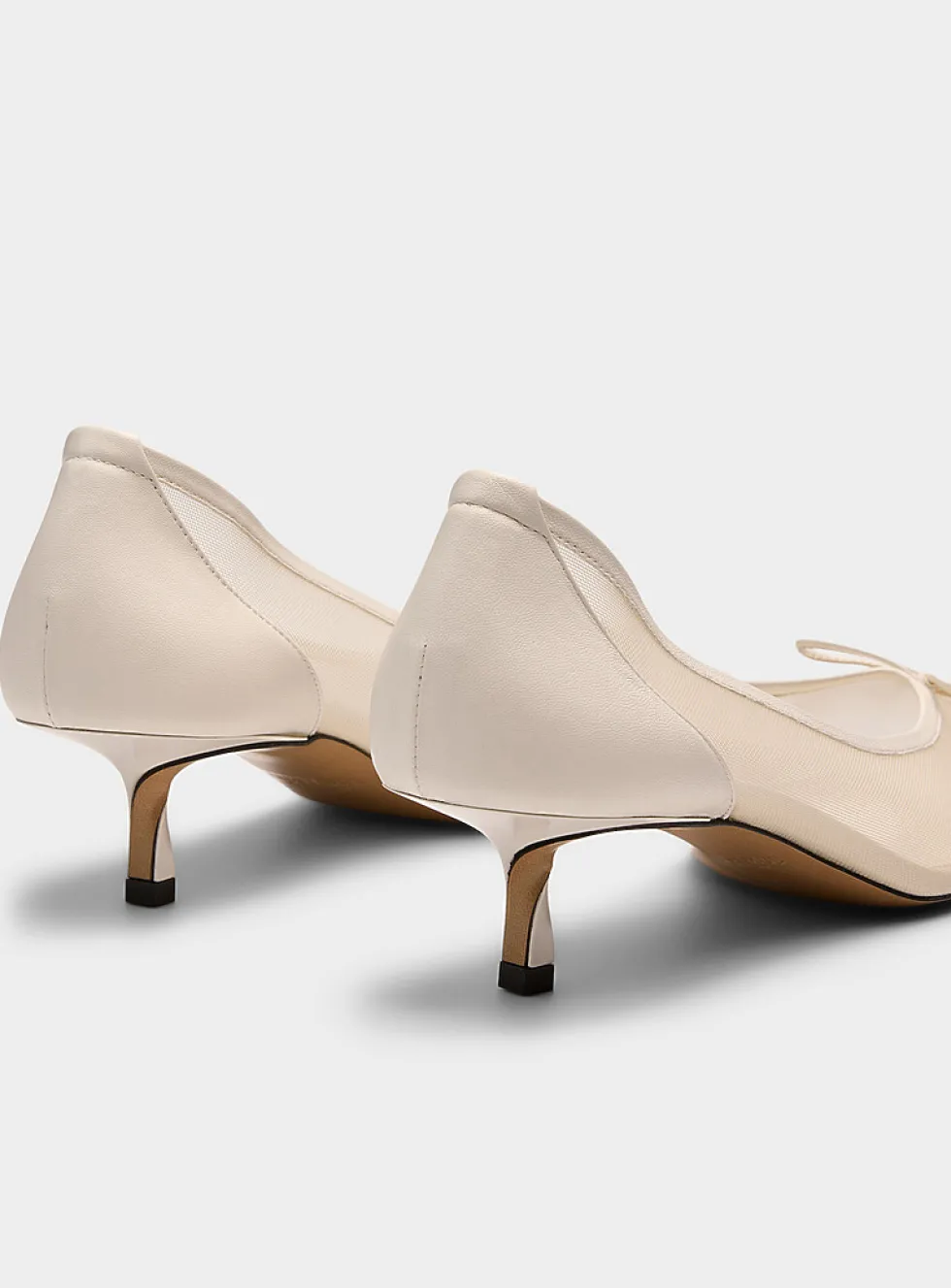 Tourni twisted heel sheer pumps